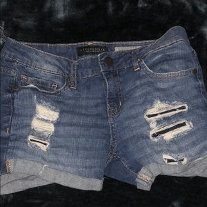Distressed denim shorts.